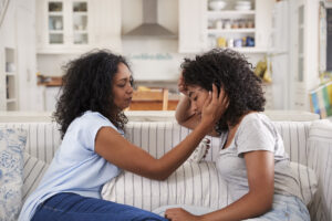 mother comforting daughter