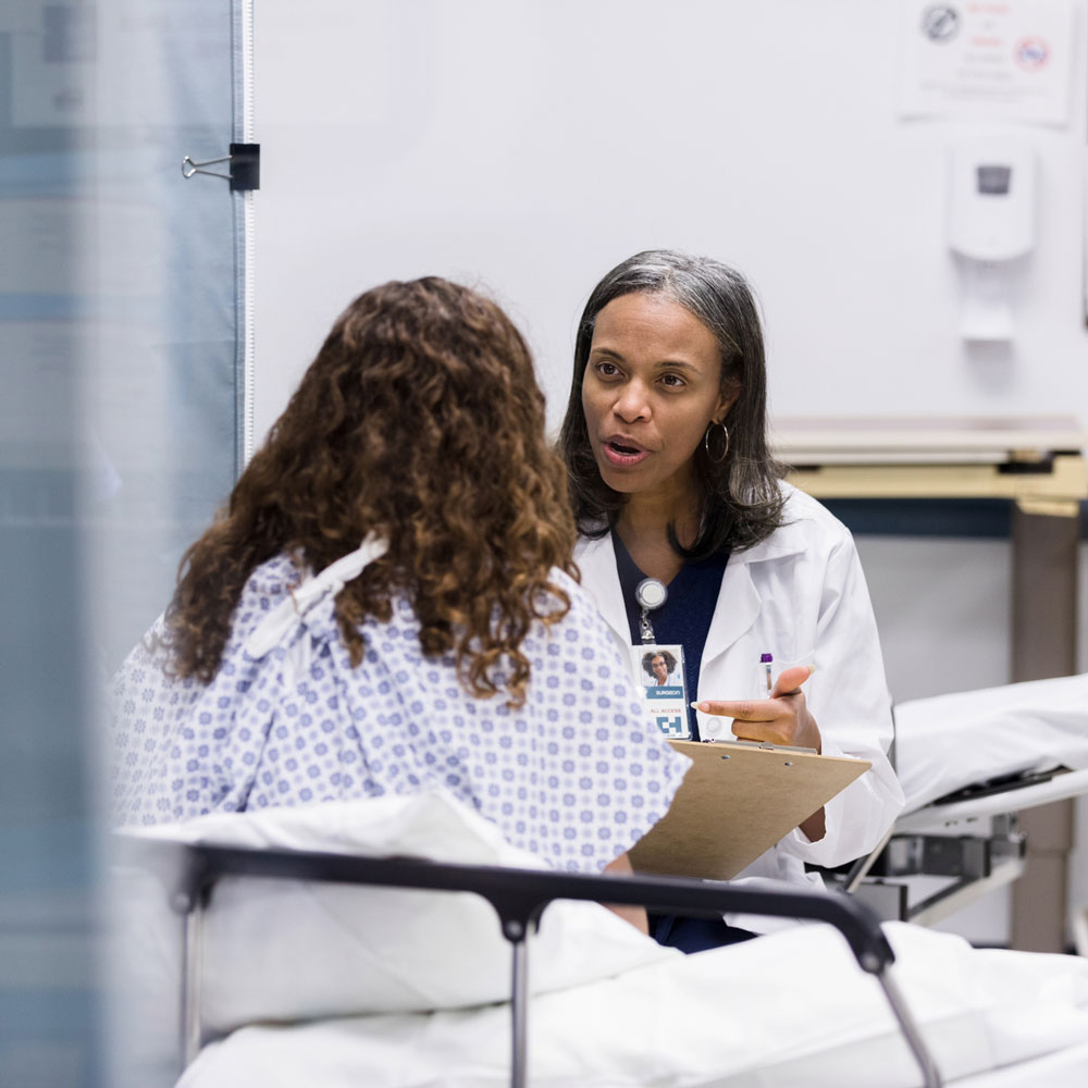 doctor speaking to patient in hospital