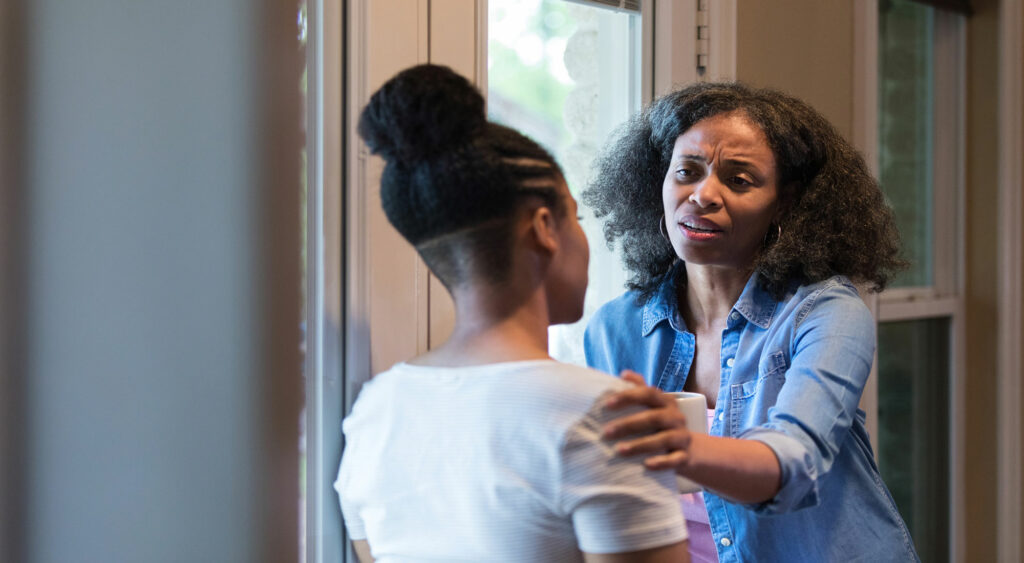 concerned mother touching daughter