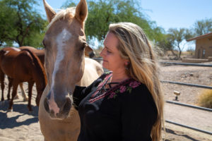 Elaine Coller works with her horses at Meadows Ranch